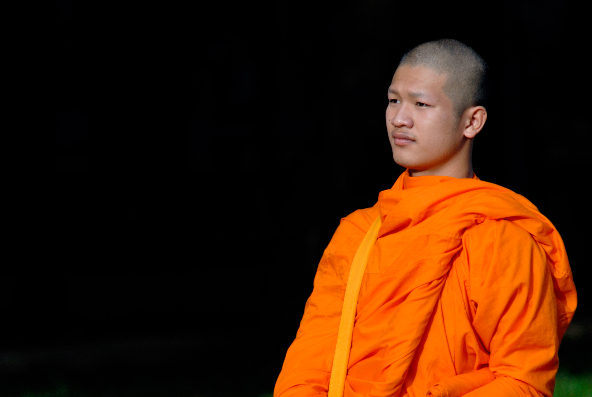 monk with side light on a dark background