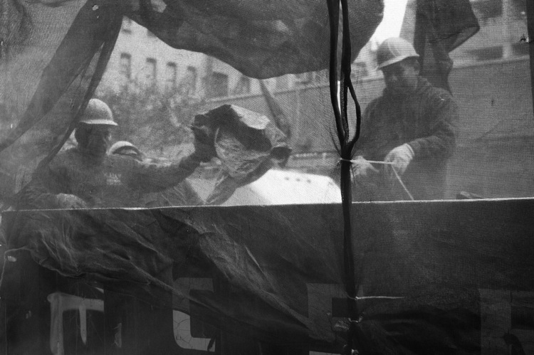 Construction workers through a screen