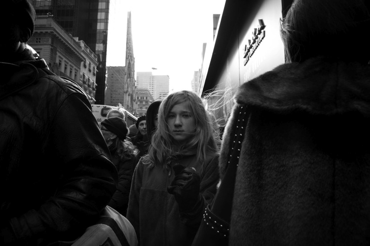 person walking through the crowd street photography