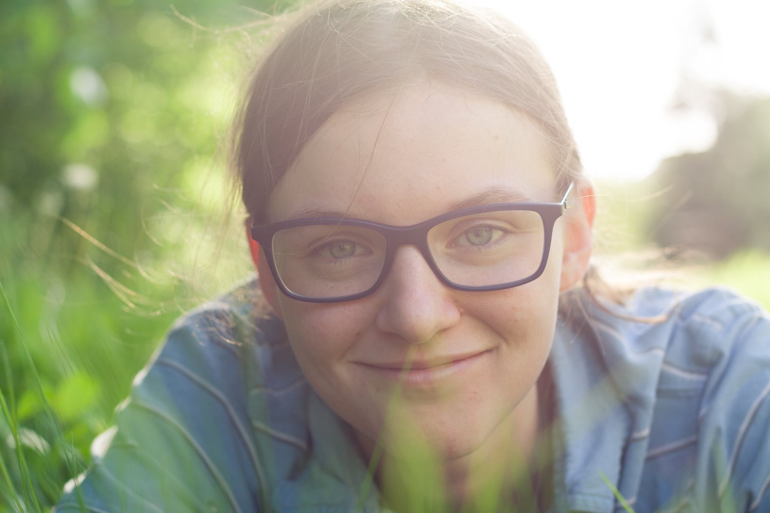 Person in the grass with a shallow depth of field effect